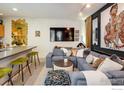 Stylish living room with modern gray sofa, fireplace, and media setup at 801 Confidence Dr # 2, Longmont, CO 80504