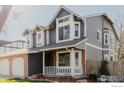 Attractive two-story home with gray siding, a brick accent, and well-maintained landscaping, showcasing curb appeal at 918 E 132Nd Ave, Thornton, CO 80241