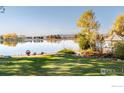 Picturesque backyard with manicured lawn, lake access, fire pit, and gazebo perfect for relaxing at 9402 Crystal Ln, Longmont, CO 80503