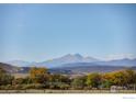 Scenic mountain views with rolling hills and trees from this beautiful property at 9402 Crystal Ln, Longmont, CO 80503