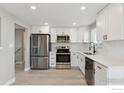 Modern kitchen featuring stainless steel appliances, white cabinetry, and quartz countertops at 9525 Damon Dr, Northglenn, CO 80260