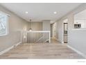 Open living space featuring hardwood floors, neutral paint, and easy access to the kitchen at 9525 Damon Dr, Northglenn, CO 80260