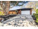 Well-maintained home featuring a large driveway and mature landscaping at 1153 Atwood St, Longmont, CO 80501