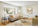 Cozy living room featuring a large window, comfortable seating, and stylish decor at 1153 Atwood St, Longmont, CO 80501