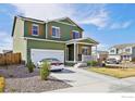 Attractive two-story home featuring an attached two-car garage, well-maintained lawn, and inviting front porch at 1157 Savona Ave, Fort Lupton, CO 80621