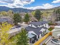 Aerial view of a modern home with a fenced yard, and a neighborhood in a mountain setting at 1175 Evergreen Ave, Boulder, CO 80304