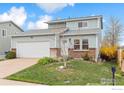 Charming two-story home with a well-maintained front yard and attached garage at 11833 W Marlowe Pl, Morrison, CO 80465