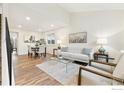 Open-concept living room featuring a dining area and a seating area with large windows at 11833 W Marlowe Pl, Morrison, CO 80465