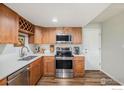 Well-equipped kitchen with stainless steel appliances, wood cabinets, and light countertops at 1226 Atwood St, Longmont, CO 80501