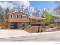 Inviting two-story home with a well-manicured front yard and a modern garage door at 1315 Brookfield Dr, Longmont, CO 80501