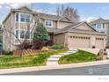 Beautiful two-story home with a three-car garage and lush front yard at 13680 Fall Creek Cir, Broomfield, CO 80020