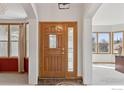 Warm foyer with a stylish front door and ample natural light at 13680 Fall Creek Cir, Broomfield, CO 80020