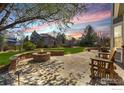 Backyard patio with a stone fire pit and built-in seating for outdoor entertaining at 2066 Ridgeview Way, Longmont, CO 80504