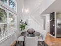 Bright dining room with a modern table, stylish chairs, and abundant natural light from large windows at 2069 N Fork Dr, Lafayette, CO 80026