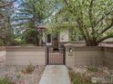 Inviting home exterior with a gated entrance and manicured landscaping in a beautiful setting at 2069 N Fork Dr, Lafayette, CO 80026