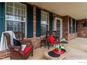 A welcoming front porch with brick accents, comfortable seating, and a cozy atmosphere at 2225 Clayton Cir, Superior, CO 80027