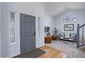 Bright foyer featuring hardwood floors and a glimpse into the adjacent living room at 2547 Concord Cir, Lafayette, CO 80026
