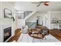 Open living area with a fireplace and staircase at 3504 Newton St, Denver, CO 80211