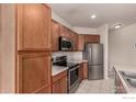 Kitchen boasts stainless steel appliances, tile flooring, and generous cabinet storage at 3577 Molly Cir, Broomfield, CO 80023