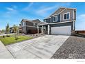 This two-story home has a two-car garage, covered porch, and modern exterior paint at 4202 Sandstone Dr, Mead, CO 80504