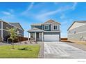 Charming two-story home boasts a two-car garage and a beautifully landscaped front yard at 4202 Sandstone Dr, Mead, CO 80504
