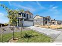 Two-story home features a well-manicured lawn and a concrete driveway at 4202 Sandstone Dr, Mead, CO 80504