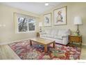 Bright living room featuring large window, wood floors, modern decor, and comfortable furnishings at 4820 W 125Th Ave, Broomfield, CO 80020