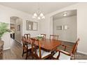 Dining area with hardwood floors and traditional furnishings, perfect for Gathering meals at 6739 Blue Spruce St, Frederick, CO 80530