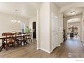 Formal dining room featuring hardwood floors, a chandelier, and neutral paint at 6739 Blue Spruce St, Frederick, CO 80530