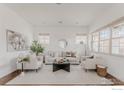Bright living room with modern decor, stylish furniture, large windows and an elegant area rug at 869 Bluestem Ln, Louisville, CO 80027