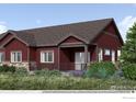 Beautiful single-Gathering home featuring a red exterior, landscaped front yard, covered front porch, and eye-catching curb appeal at 900 W 128Th Pl, Westminster, CO 80234