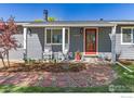 Close up of the front of the home, with stylish front porch and well manicured lawn at 9951 Sierra Vista Rd, Longmont, CO 80504