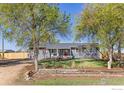 Charming single-story home featuring well-maintained landscaping and a cozy front porch at 9951 Sierra Vista Rd, Longmont, CO 80504