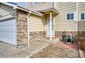 Inviting front entrance featuring stone accents and covered porch area at 10635 E 96Th Pl, Commerce City, CO 80022