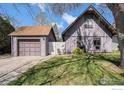 Charming home featuring a detached garage, cozy front yard, and inviting curb appeal with a small patio set at 114 Placer Ave, Longmont, CO 80504