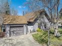 Charming home featuring a detached garage, cozy front yard, and inviting curb appeal with a small patio set at 114 Placer Ave, Longmont, CO 80504