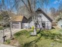 Charming home featuring a detached garage, cozy front yard, and inviting curb appeal with a bench in yard at 114 Placer Ave, Longmont, CO 80504