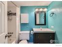 Charming bathroom featuring bright blue walls, a shower-tub, a modern vanity, and sleek fixtures at 1366 Garfield St # 209, Denver, CO 80206