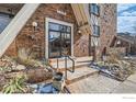Inviting entrance to a brick apartment building with landscaped surroundings and a secure entry at 1366 Garfield St # 209, Denver, CO 80206