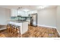 Modern kitchen with stainless steel appliances, granite countertops, and a stylish breakfast bar at 1366 Garfield St # 209, Denver, CO 80206