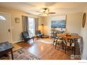 Cozy living room features hardwood floors, stylish furnishings, and ample natural light from a large window at 1504 Washington Ave, Louisville, CO 80027