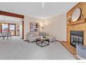 Living room with fireplace, wood mantle, and an open floor plan at 1590 Garfield Ave # B, Louisville, CO 80027