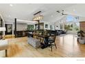Bright and spacious open-concept living area with modern decor, hardwood floors, and a large dining table at 182 Ridge Rd, Boulder, CO 80303