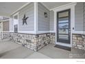 Stylish modern front door with glass panels and covered entryway at 1916 High Plains Dr, Longmont, CO 80503