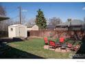 A cozy backyard features a fire pit and additional storage shed at 2071 W 54Th Pl, Denver, CO 80221