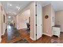 Inviting entryway showcasing hardwood floors, archways, and natural light, leading to the living and dining areas at 2353 S Juniper Way, Lakewood, CO 80228