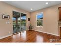 Bright living space with hardwood floors, a sliding glass door, and views of the outdoor patio area at 2353 S Juniper Way, Lakewood, CO 80228