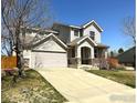 Two-story home with front porch, two-car garage and a long driveway at 2432 Tyrrhenian Dr, Longmont, CO 80504