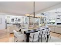 Open-concept dining room with modern lighting and seamless connection to living and kitchen areas at 3021 Jefferson St, Boulder, CO 80304