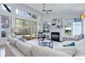 Bright living room features high ceilings, a fireplace, and expansive windows with backyard views at 3021 Jefferson St, Boulder, CO 80304